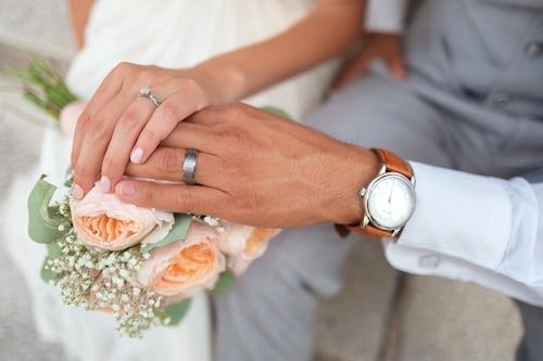 two persons getting married ,holding hands